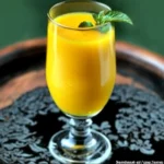 Refreshing glass of homemade mango juice with mint garnish